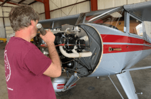 A&P Mechanic repairing airplane engine